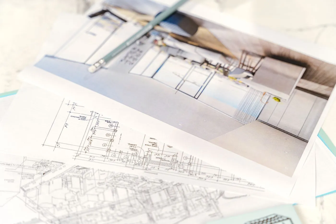 Architectural blueprints and a 3D sketch on a desk