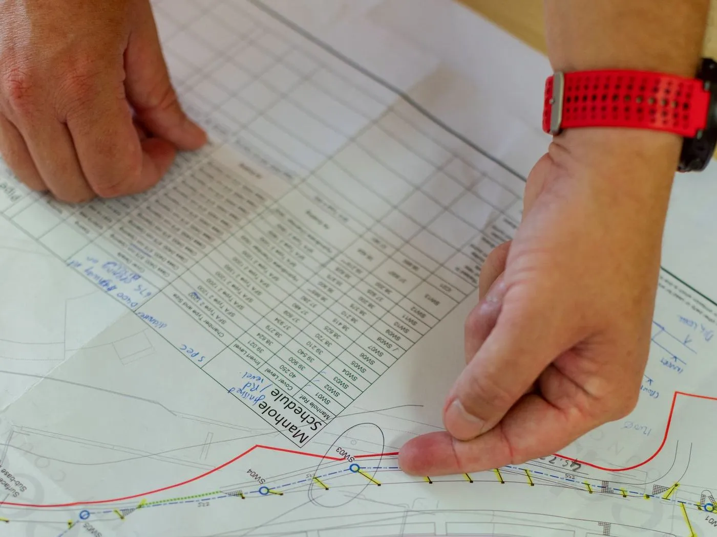 Estimator pointing to a schedule on a drawing sheet