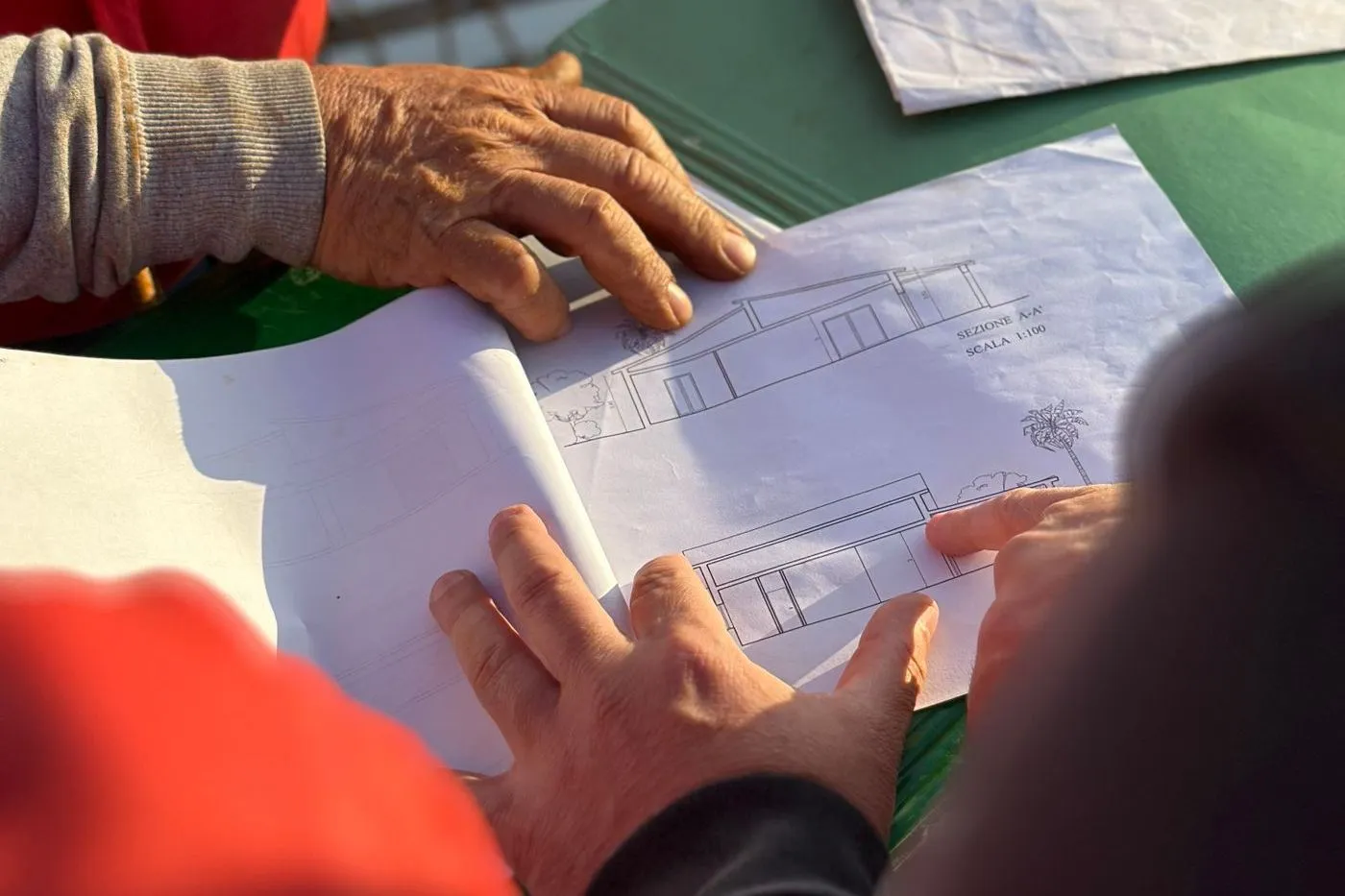 Construction team going through a drawing set on a site table