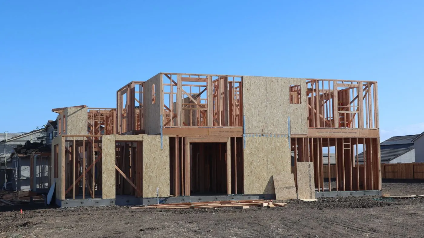 Two-story wood-framed house under construction