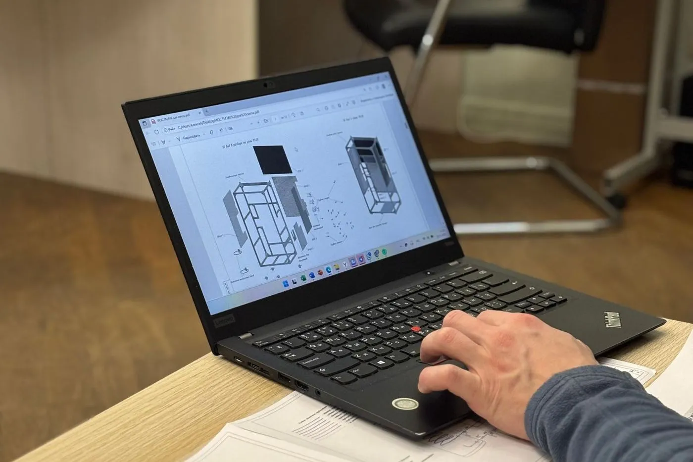 Estimator reviewing building drawings on a laptop
