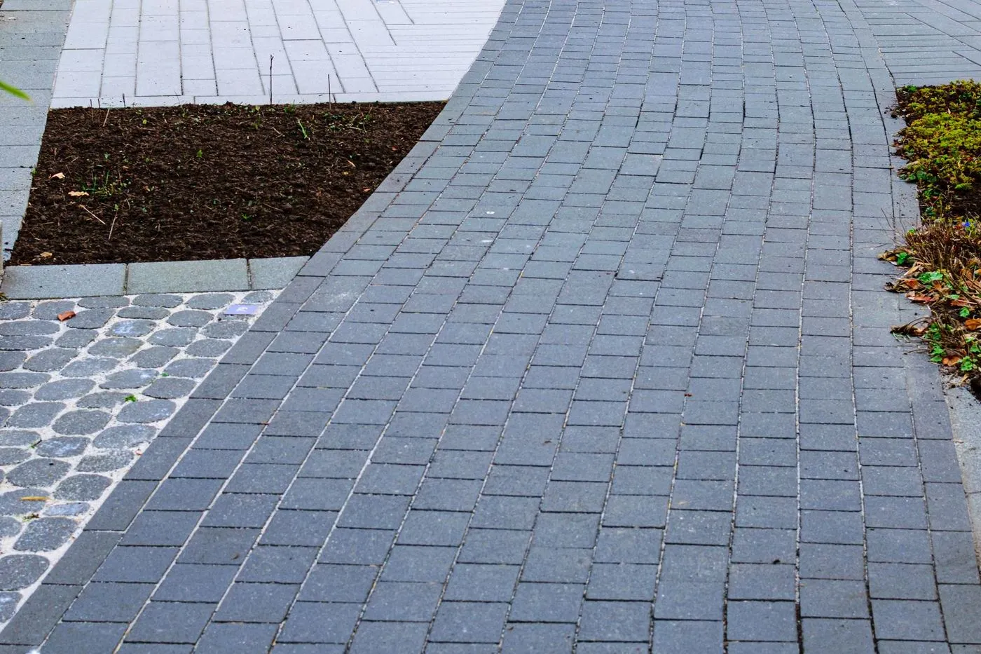 Brick pathway through a landscaped garden