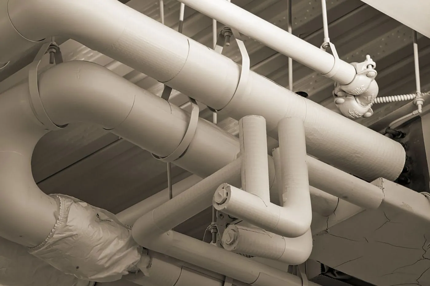 Pipes and ducts running through a building ceiling