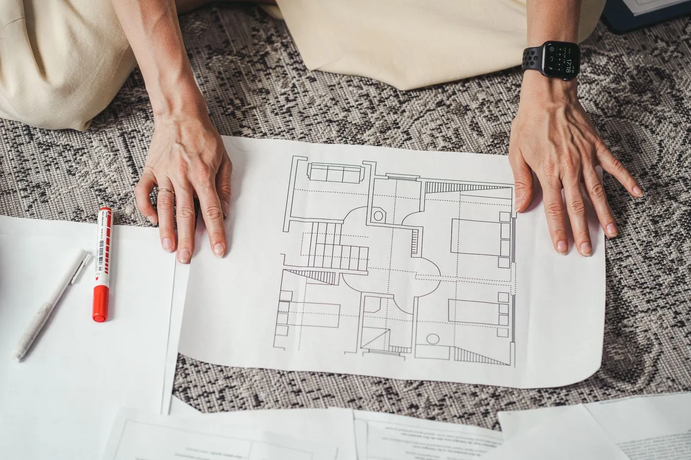 Hands on a residential floor plan drawing