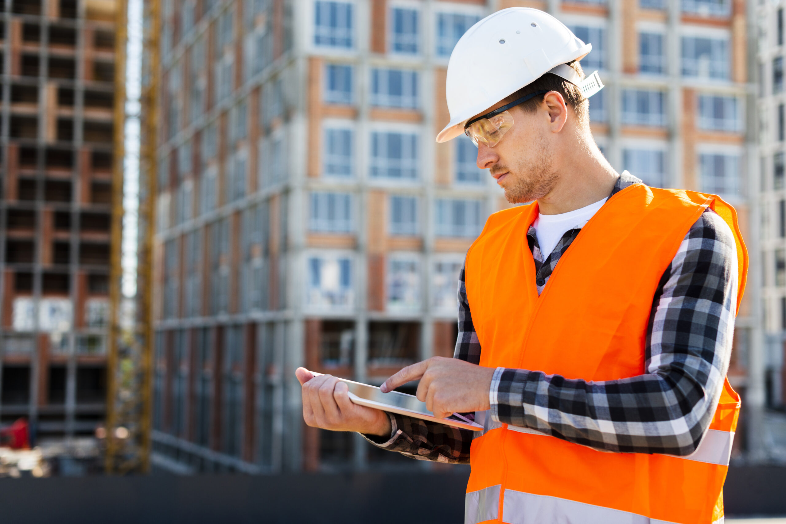Deciding on Construction Management Software for Small Businesses 1 medium shot side view construction engineer using tablet scaled